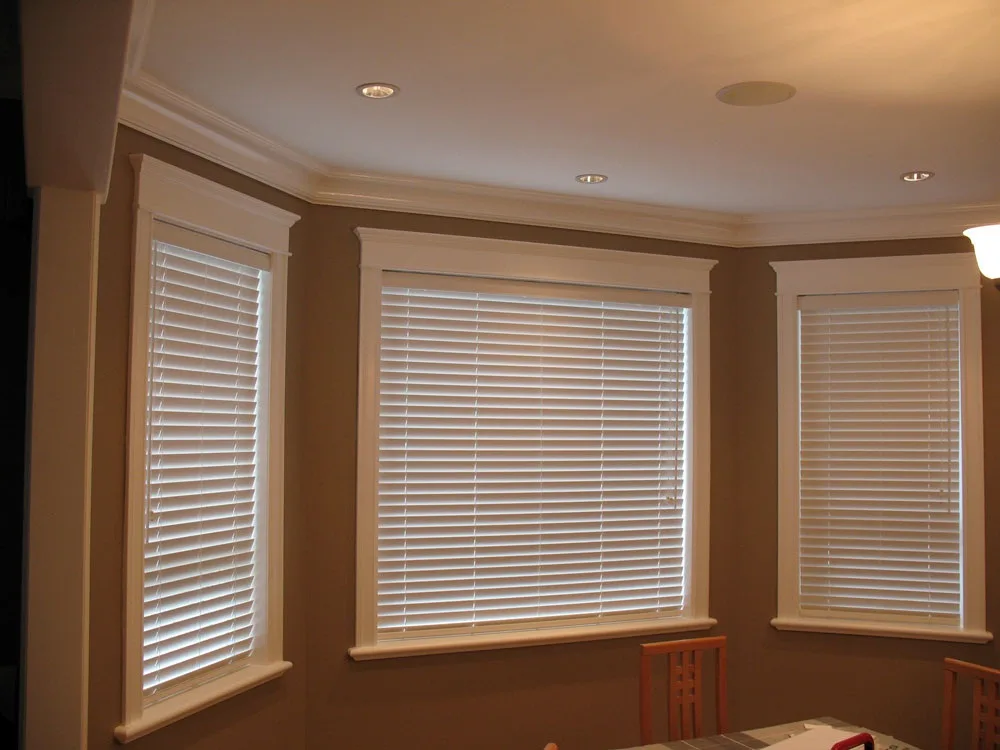 Installer fitting elegant window shades inside Lakewood, CA residence