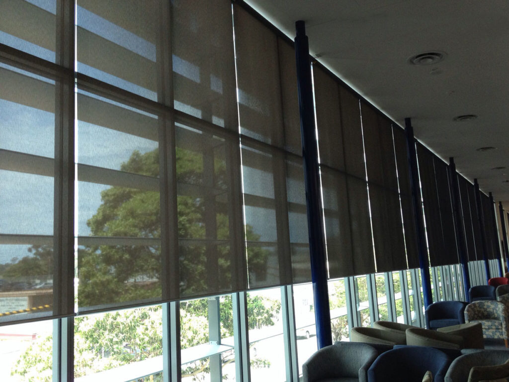 Stylish roller shades installed neatly by Blinds by Design crew