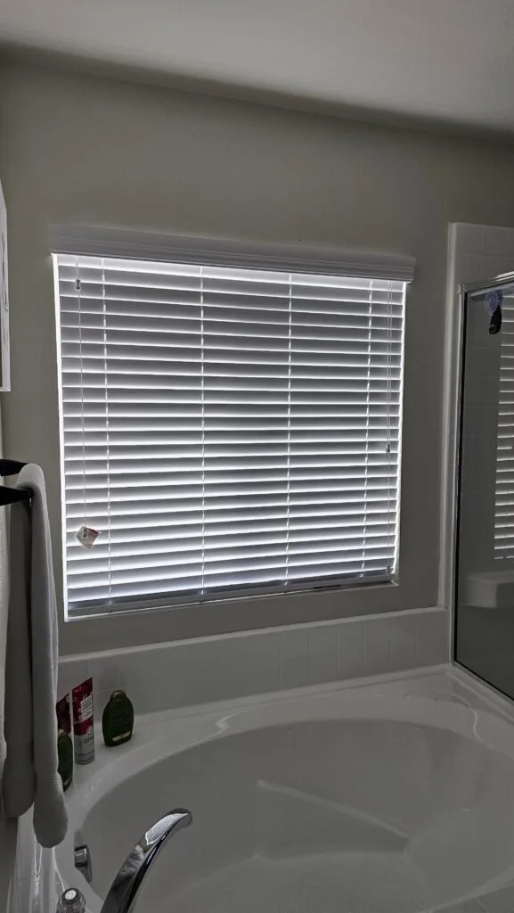 Custom window blinds installed by Blinds by Design near sunny window