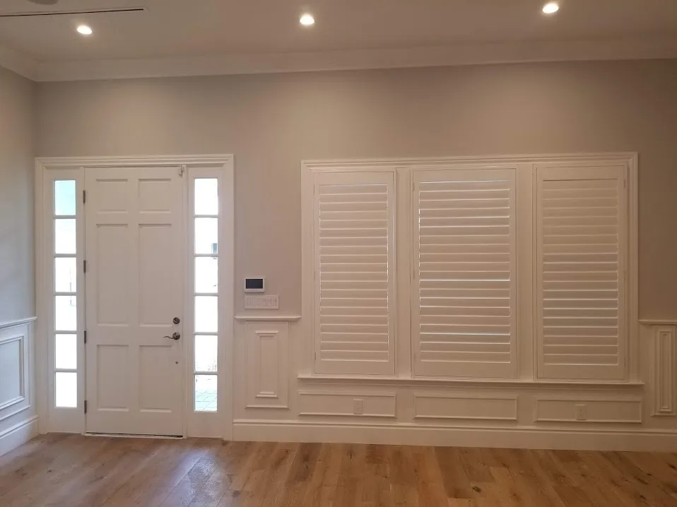 Elegant plantation shutters on a sunny Whittier living room window
