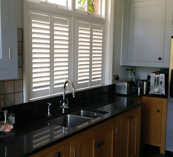 Installing white shutters in Fullerton, CA home