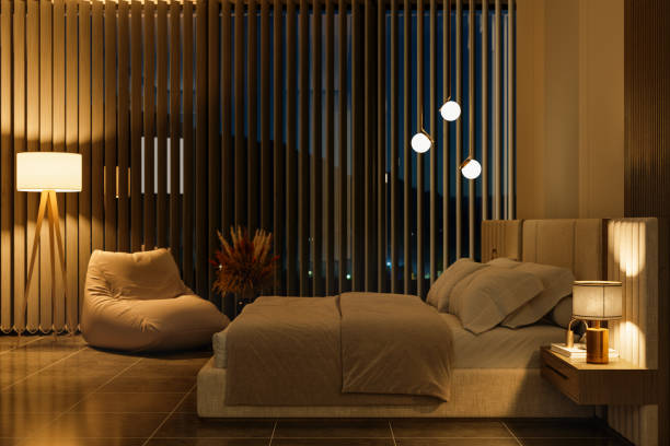 Modern Bedroom Interior With Side View Of Night Table And Double Bed At Night