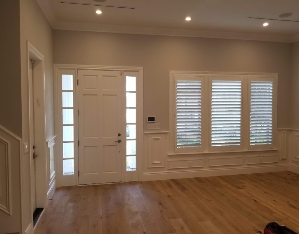 White plantation shutters mounted inside a living room