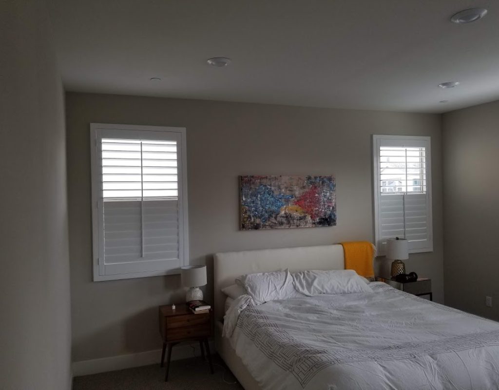 White plantation shutters mounted inside a living room