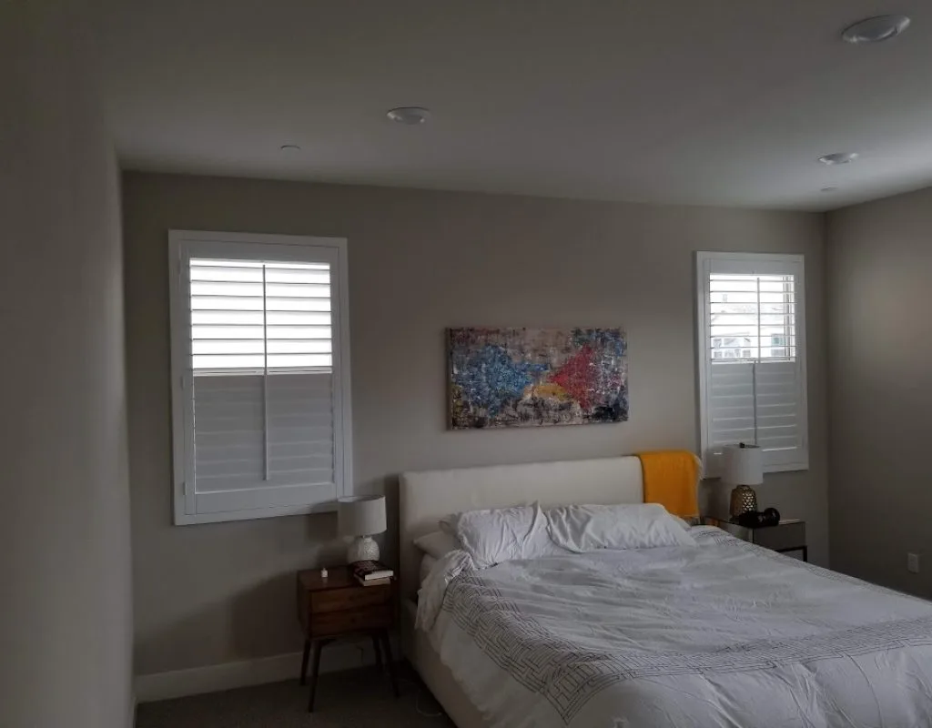 White plantation shutters mounted inside a living room