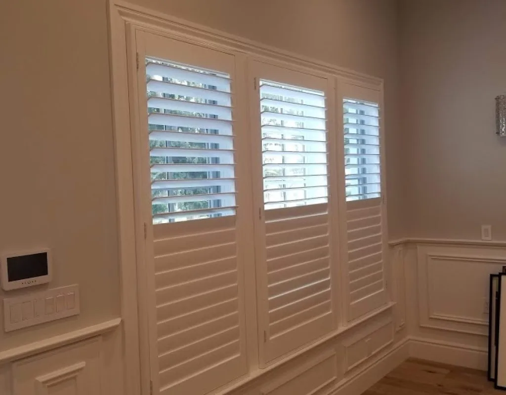 Custom shutter installation by Blinds by Design technician