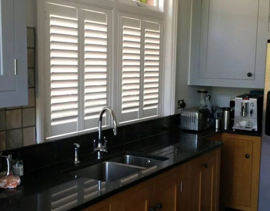 Installing white shutters in Fullerton, CA home