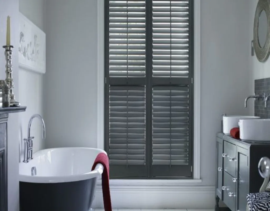 White wooden shutters professionally mounted by Blinds by Design installer
